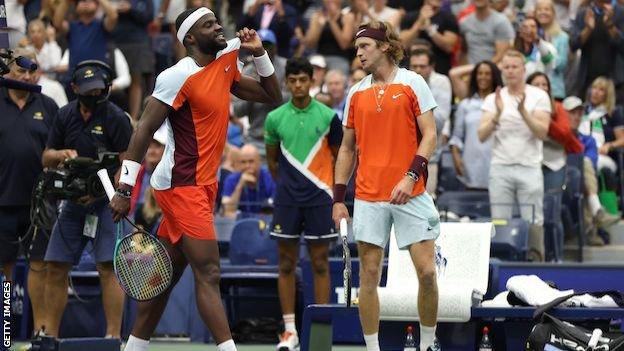 Frances Tiafoe celebrates in front of Andrey Rublev